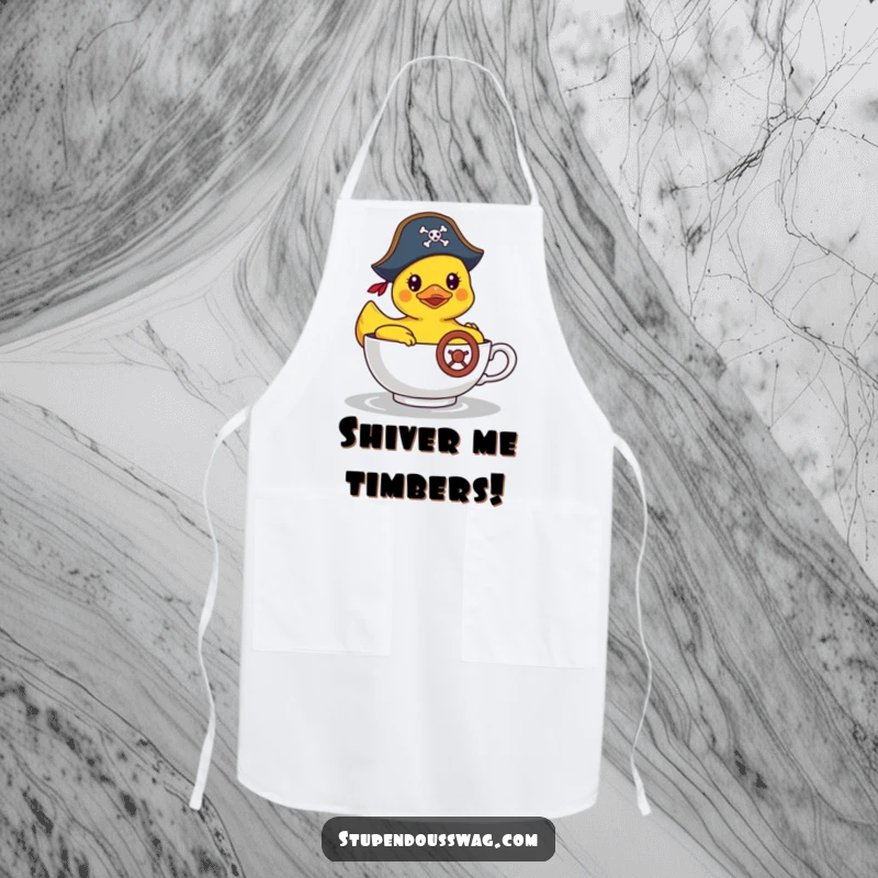 Funny apron depicting a rubber duck in a pirate hat steering a teacup, great for kitchen fun and protection with humor.