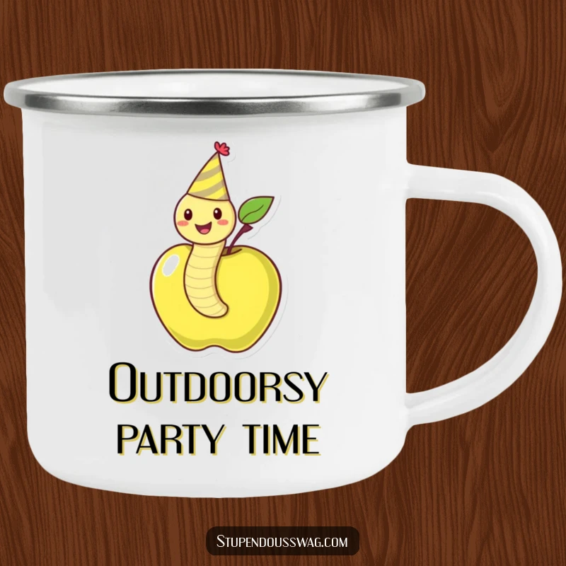 Funny camping mug showing a happy worm in a party hat emerging from an apple, ready for outdoor festivities.