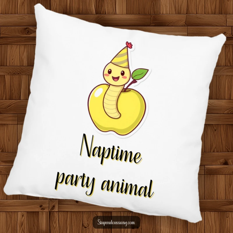 Funny pillow displaying a happy worm wearing a party hat, emerging from an apple, offering comfort and amusement.