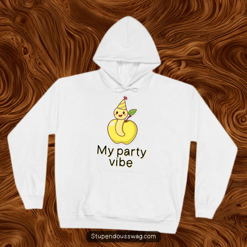 Funny hoodie featuring a happy worm wearing a party hat, joyfully peeking out of an apple, designed for ultimate cozy fun.
