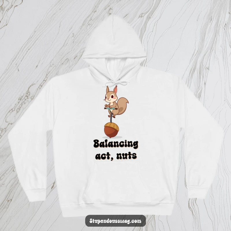 Funny hoodie showing a mischievous squirrel balancing on a giant acorn unicycle, providing warmth and a humorous visual.