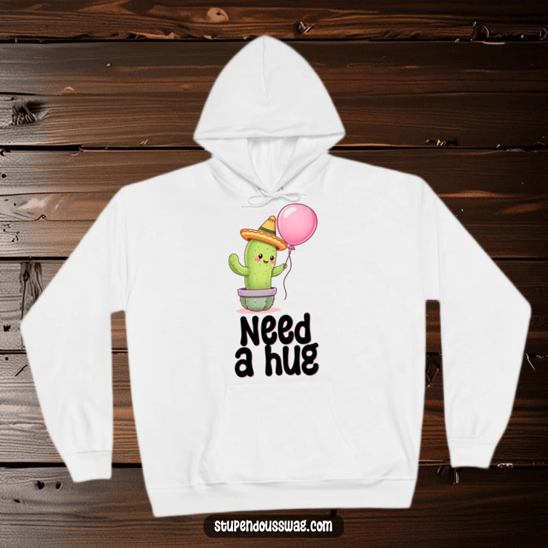 Funny hoodie showing a cactus in a tiny sombrero attempting to hug a balloon, providing warmth and a humorous visual.