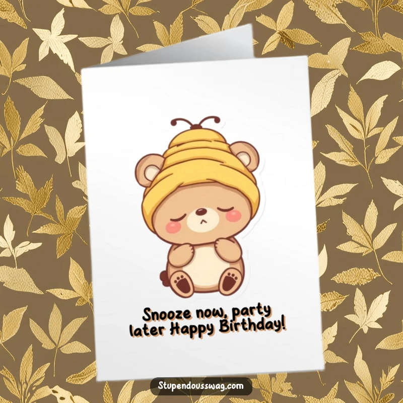 Funny free printable birthday card: Sleepy bear comically attempts to wear a buzzing beehive as a birthday hat.