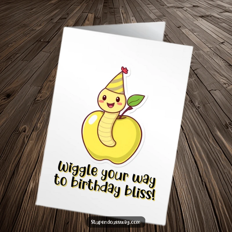 Funny Free Printable Birthday Card: A jubilant worm sporting a party hat joyfully wiggles out of a ripe red apple, wishing a happy birthday.