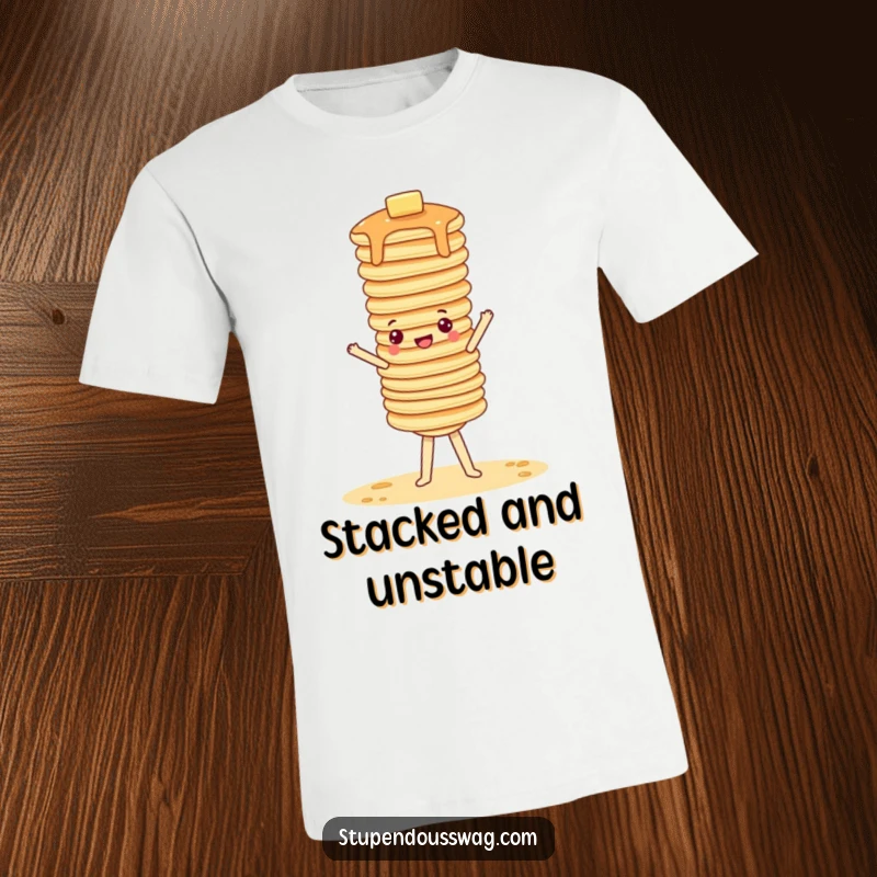 Funny t-shirt featuring a stack of pancakes attempting an ambitious, wobbly handstand, perfect for breakfast fans.