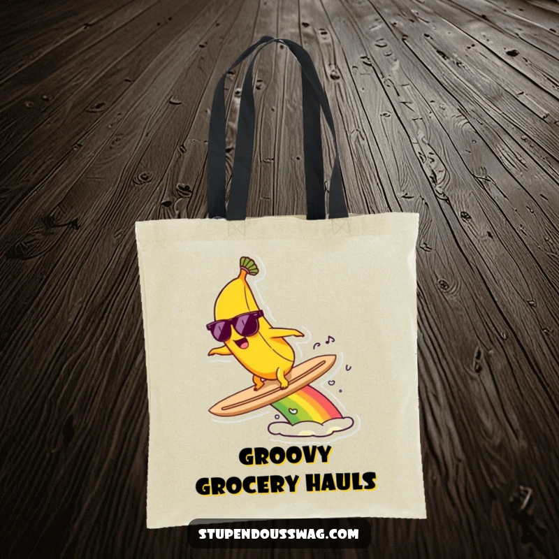 Funny tote bag with a banana wearing sunglasses, surfing a vibrant rainbow, ready for any adventure.