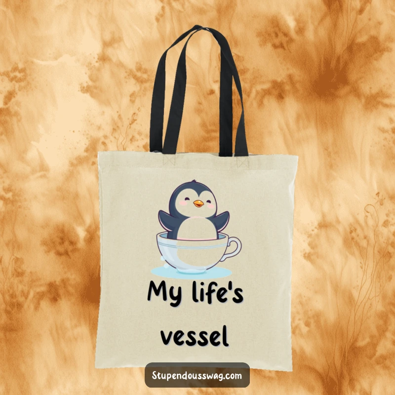 Funny penguin teacup tote bag with a dizzy bird sailing in a coffee cup, a humorous and practical gift.