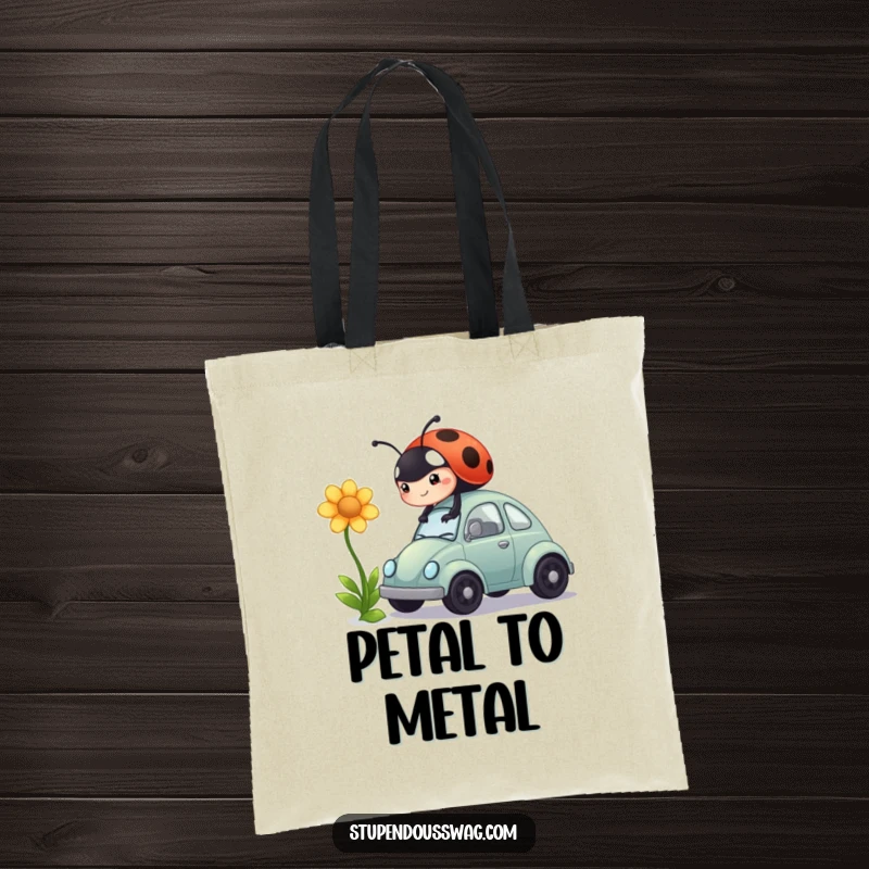 Funny tote bag showcasing a ladybug's comical attempt to drive a miniature car powered by a flower, a scene of determination.