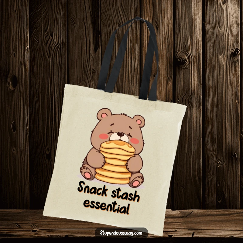 A clumsy bear balancing pancakes on its nose, featured on a durable tote bag, ready to carry essentials with a humorous touch.
